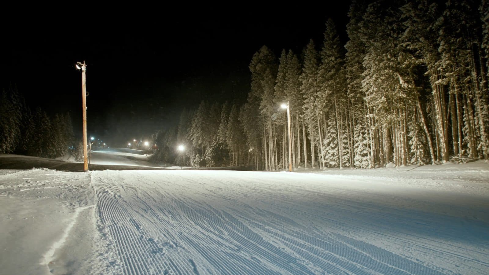 Floodlit ski piste at night