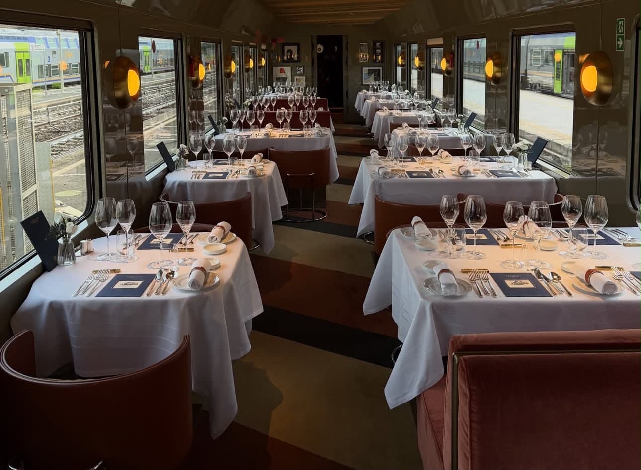 Chefs' Carriage — tables laid in white linen, velvet armchairs